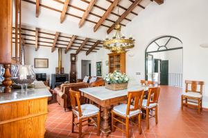 a kitchen and living room with a table and chairs at Villa Rafal Fort by Escape Home in Alaior