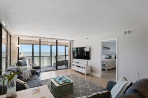 a living room with a view of the ocean at #504 Shores of Madeira in St Pete Beach