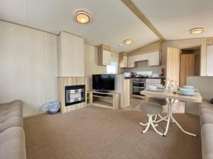 a kitchen with a couch and a table in a room at Waterside Holiday Park in Goodrington