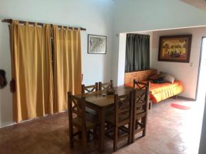 a dining room with a table and a bed at Cabaña Steinbock in Capilla del Monte