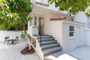 a white house with stairs and a table at Villa Italic in Antalya