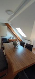 a large wooden table in a room with chairs at Buergerhaus Zeltingen Fewo in Zeltingen-Rachtig +26 photos