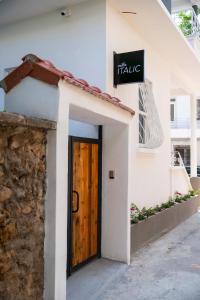 a white building with a wooden door on it at Villa Italic in Antalya