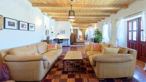 a living room with two couches and a table at Villa Kluni by Rent Istria in Momjan +43 photos