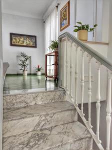 a hallway with stairs with potted plants at R&D Rest and Dream Capri in Anacapri