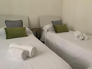 two beds with towels on them in a room at San Marco Charming Suite in Venice