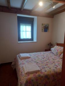 a bedroom with a bed with two towels on it at La Casina de Póo de LLanes in Po +15 photos