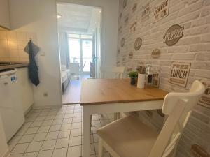 a kitchen and dining room with a table and chairs at Charming Apartment - Balcony - Netflix - Kitchen in Magdeburg