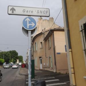 a street sign on a street with a sign for a care istg at chez MARINO antony real in Orange