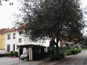 a car parked under a bus stop in front of a house at Penzion Ema B&B in Prostějov