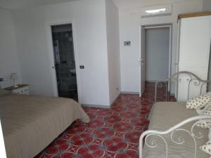 A bed or beds in a room at R&D Rest and Dream Capri