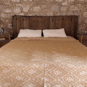 a bed with two pillows on top of it at Trullo Contrada Stracca in Alliste