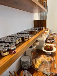 a kitchen with a shelf with food on it at Card International Hotel in Rimini