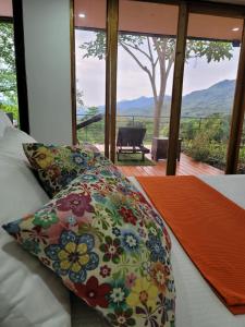 a bedroom with a bed with a pillow and a window at Casa Ensueño Hogar Boutique in Guaduas