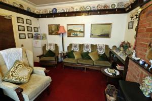 a living room with couches and chairs at Rosamaly Guesthouse in Hunstanton