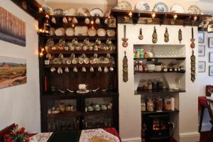 a room with a wall filled with lots of dishes at Rosamaly Guesthouse in Hunstanton