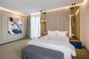 a hotel room with two beds and a bench at Onal Boutique Hotelier in Mamaia