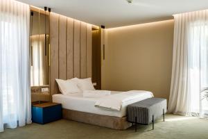 a small bedroom with a bed and a window at Onal Boutique Hotelier in Mamaia