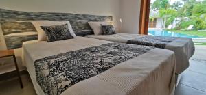 Postel nebo postele na pokoji v ubytování Flor de Coco, Villa neuve, 5 chambres, 5 salles de bains et grande piscine à 250 mètres de la plage
