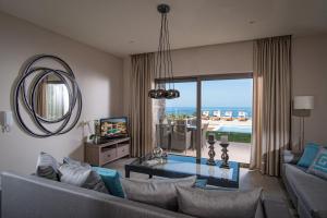 a living room with a couch and a table and a mirror at Villa Belamar in Hersonissos