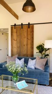 a blue couch in a living room with a glass table at Finest Retreats - Blackbarn Wood in Balsham