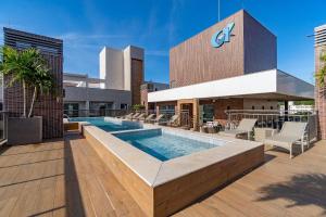a swimming pool on the roof of a building at Porto Madero - Apartamento Alto Padrão em Condo com Piscina in Bombinhas +23 photos