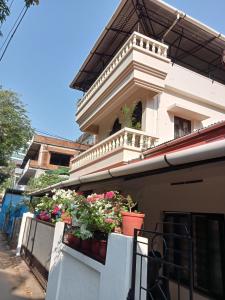a building with potted plants on a balcony at Padamadan homestay in Cochin