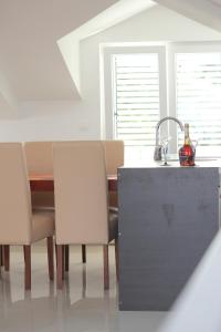 a kitchen with a table and chairs and a sink at Penthouse by the Sea in Tivat