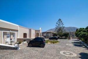 a car parked in the driveway of a house at George Apartment in Vóthon