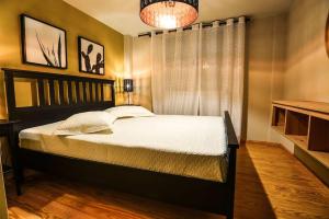a bedroom with a bed and a chandelier at Aigli Luxurious Villa in Káto Pitsá
