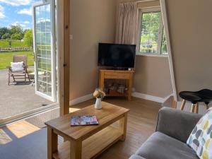 a living room with a tv and a table at Hideaway in Bradford on Avon