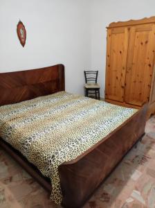 a bedroom with a bed with a leopard print bedspread at Casa vacanze ferro in Trapani