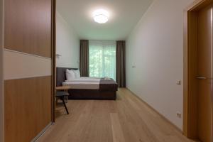 a hotel room with a bed and a window at Oasis Apartments in Jūrmala