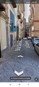 an empty street with white writing on the ground at B&B Napul'è in Naples