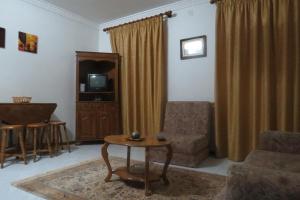 a living room with a chair and a table and a tv at Casa Das Lages in Alvoco da Serra