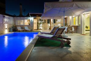 a swimming pool with a lounge chair and an umbrella at Apartment Nedo in Sveti Filip i Jakov