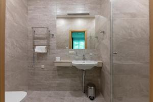 a bathroom with a sink and a mirror at Oasis Apartments in Jūrmala +29 photos