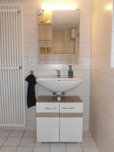 a bathroom with a sink and a mirror at Zum Hochufer in Lohme +6 photos