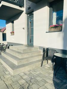 a patio with stairs and a table and chairs at Apartmány TAMKA in Vrbov