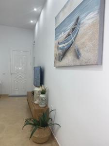 a room with a painting of a boat on the wall at CABO BEACH II in El Cabo de Gata