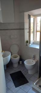 a bathroom with a toilet and a bidet and a sink at La Tana di Margherita in Perugia