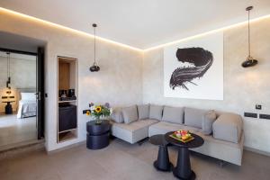 a living room with a couch and a table at Tropicana Hotel , Suites & Villas Mykonos in Paradise Beach