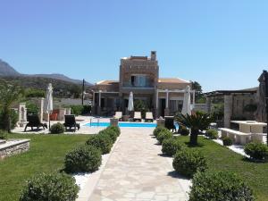 a villa with a swimming pool and a house at Blue Horizon Villa & Suites in Sitia