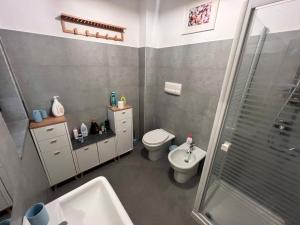 a bathroom with a toilet and a sink and a shower at ZEFIA HOME in Catania