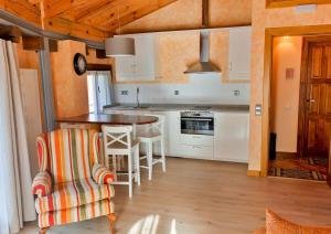a kitchen with white cabinets and a table and chairs at La Casa del Abad in Anguiano