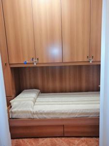 a bed in a wooden cabinet in a room at Il Gioiello Nel Parco - Sanremo Apartments in Sanremo