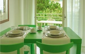 a green table with chairs and a table with plates at Trilo in Cattolica