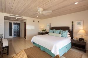 a bedroom with a large bed with a ceiling at Curtain Bluff - All Inclusive in Old Road