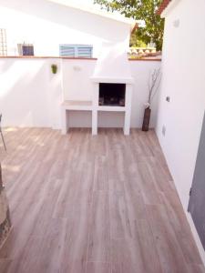 a living room with a wood floor and a fireplace at Delightful Villa close to the beach in L'Escala