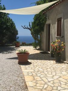 un patio con macetas junto a un edificio en La Terrazza Del Duca, en Marina di Camerota